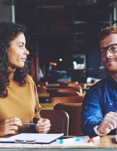 Man and Woman at desk in meeting