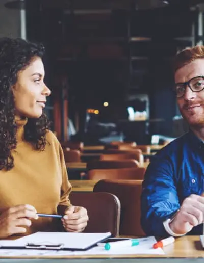 Man and Woman at desk in meeting